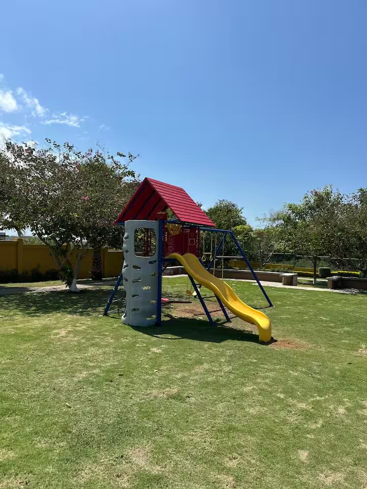 Children’s playground with a slide on the lawn