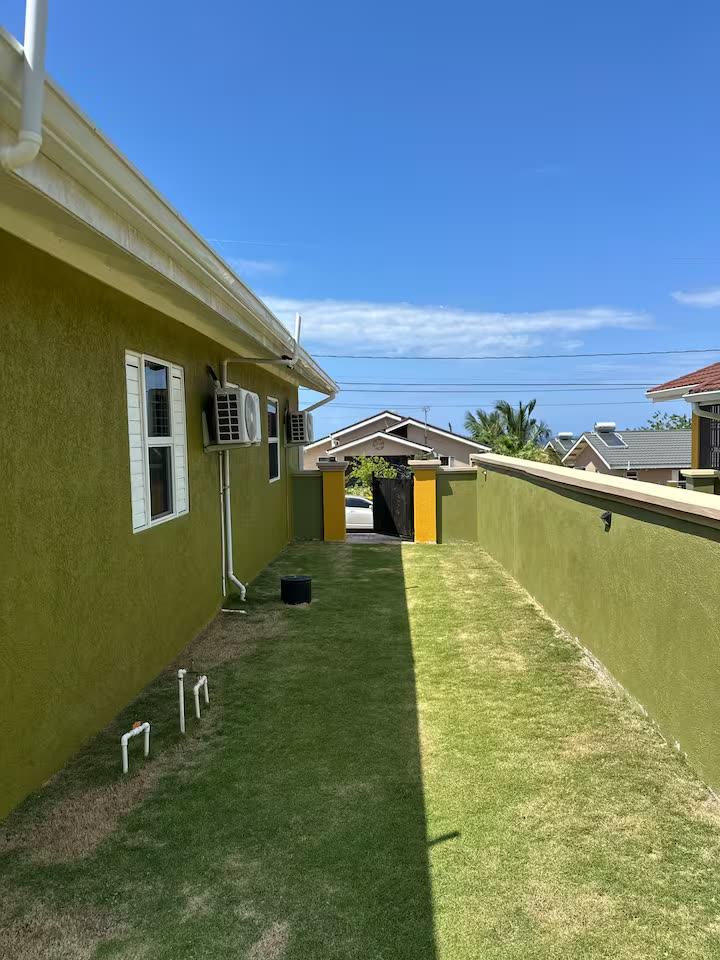 Long side yard along the green house wall